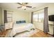 A bright and comfortable bedroom with hardwood floors, ceiling fan and large window with neighborhood views at 29110 N 24Th Ln, Phoenix, AZ 85085