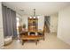 Dining area offering a wooden table with bench seating, tile flooring and ample natural light at 29110 N 24Th Ln, Phoenix, AZ 85085