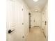 Bright hallway with tile flooring and white doors, leading to various rooms at 29110 N 24Th Ln, Phoenix, AZ 85085