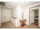 Second floor hallway featuring neutral carpet and walls plus a decorative accent table and lighting at 29110 N 24Th Ln, Phoenix, AZ 85085