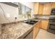 This kitchen showcases ample countertop space, updated appliances and a modern faucet at 29110 N 24Th Ln, Phoenix, AZ 85085