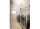 Modern laundry room with shelving and stainless steel washer and dryer at 29110 N 24Th Ln, Phoenix, AZ 85085