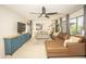 Inviting living room features neutral decor, a ceiling fan, and light-filled windows with patio views at 29110 N 24Th Ln, Phoenix, AZ 85085