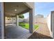 Covered back patio with artificial turf and gravel landscaping at 29270 W Weldon Ave, Buckeye, AZ 85396
