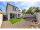 Backyard featuring artificial turf, rock landscaping, and a covered patio at 29270 W Weldon Ave, Buckeye, AZ 85396