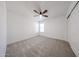 Bright bedroom featuring neutral carpet, a ceiling fan, and ample natural light at 29270 W Weldon Ave, Buckeye, AZ 85396