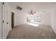 This carpeted bedroom has natural light, a ceiling fan and access to the backyard at 29270 W Weldon Ave, Buckeye, AZ 85396