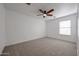 Bedroom with neutral carpet, ceiling fan, and natural light from the window at 29270 W Weldon Ave, Buckeye, AZ 85396
