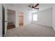 This bedroom offers neutral carpet, natural light and an overhead fan at 29270 W Weldon Ave, Buckeye, AZ 85396