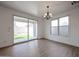 Dining area features a modern chandelier, access to the backyard, and large windows offering lots of natural light at 29270 W Weldon Ave, Buckeye, AZ 85396