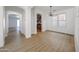 Bright dining room features modern light fixture and light wood-look floors at 29270 W Weldon Ave, Buckeye, AZ 85396