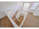 A bright foyer with hardwood floors, grand staircase, a pendant light and lots of natural light at 29270 W Weldon Ave, Buckeye, AZ 85396