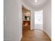 Hallway with wood floors and an arched doorway to the bathroom and living room at 29270 W Weldon Ave, Buckeye, AZ 85396