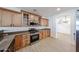 Well-lit kitchen features wood cabinets, granite countertops, and stainless steel appliances at 29270 W Weldon Ave, Buckeye, AZ 85396