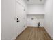 Practical laundry room with white walls and shelving at 29270 W Weldon Ave, Buckeye, AZ 85396