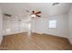 Bright living room with wood floors, a ceiling fan, and a view to the landing at 29270 W Weldon Ave, Buckeye, AZ 85396