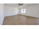 Large open-concept living room with neutral walls and tile flooring throughout at 29270 W Weldon Ave, Buckeye, AZ 85396