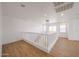 A light and airy loft space with modern lighting fixtures and neutral walls at 29270 W Weldon Ave, Buckeye, AZ 85396