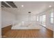 A bright and open loft area with modern lighting and balcony access at 29270 W Weldon Ave, Buckeye, AZ 85396