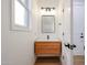 Modern powder room features wood vanity, floating sink and neutral finishes at 29270 W Weldon Ave, Buckeye, AZ 85396