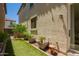 Backyard featuring artificial turf, landscaping and potted plants near stucco wall at 2947 N Sonoran Hls, Mesa, AZ 85207