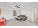 Well-lit bedroom with neutral carpet, ceiling fan, and cozy chaise lounge at 2947 N Sonoran Hls, Mesa, AZ 85207