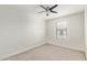 Bright bedroom features neutral carpeting, a ceiling fan, and a window with blinds at 2947 N Sonoran Hls, Mesa, AZ 85207