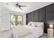 Bedroom with neutral carpet, sliding door to balcony, and dark accent wall at 2947 N Sonoran Hls, Mesa, AZ 85207
