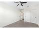 Bedroom featuring neutral carpet and a ceiling fan, with closet and doors visible at 2947 N Sonoran Hls, Mesa, AZ 85207