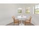 Cozy dining area with white table and seating near windows at 2947 N Sonoran Hls, Mesa, AZ 85207