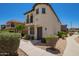 Two-story home featuring a private balcony and stucco exterior with a dark-stained front door at 2947 N Sonoran Hls, Mesa, AZ 85207