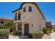 Two-story home featuring a private balcony and stucco exterior with a dark-stained front door at 2947 N Sonoran Hls, Mesa, AZ 85207