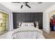Bedroom with ceiling fan, dark accent wall and walk-out at 2947 N Sonoran Hls, Mesa, AZ 85207