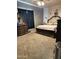 A well-lit bedroom with carpet flooring, black-out curtains, and furniture at 29935 W Roosevelt St, Buckeye, AZ 85396