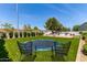 Well-maintained backyard with artificial turf, trampoline, privacy fence, and BBQ at 3030 E Camellia Dr, Gilbert, AZ 85296