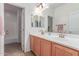 Well-lit bathroom with double sinks and a shower-tub combination at 3030 E Camellia Dr, Gilbert, AZ 85296