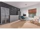 Spacious bedroom with a black chalkboard wall and a comfortable rocking chair at 3030 E Camellia Dr, Gilbert, AZ 85296
