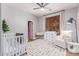 Cozy Bedroom with crib, white furniture, accent rug, and plantation shutters at 3030 E Camellia Dr, Gilbert, AZ 85296