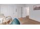Bright bedroom featuring a rocking chair and closet doors at 3030 E Camellia Dr, Gilbert, AZ 85296