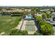 Aerial view of community pool, tennis court, grassy field, mature trees, and lounge area at 3030 E Camellia Dr, Gilbert, AZ 85296