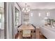 Bright dining area featuring a modern chandelier, large windows, and hardwood floors at 3030 E Camellia Dr, Gilbert, AZ 85296