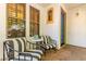 Quaint front porch featuring striped seating, a marble table, and stylish windows that create an inviting outdoor space at 3030 E Camellia Dr, Gilbert, AZ 85296