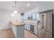 Stylish kitchen boasts modern stainless steel appliances, custom blue cabinets, and wine cooler at 3030 E Camellia Dr, Gilbert, AZ 85296