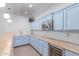 Updated kitchen features custom blue cabinets, stainless steel appliances, and ample counter space at 3030 E Camellia Dr, Gilbert, AZ 85296