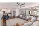 Spacious living room with a modern ceiling fan, stylish furnishings, and an open flow into the kitchen, great for gatherings at 3030 E Camellia Dr, Gilbert, AZ 85296