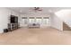 Spacious living room with a staircase and a large television, perfect for relaxing at 3030 E Camellia Dr, Gilbert, AZ 85296