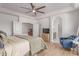 Bright main bedroom with wood floors, an arched entryway, and a cozy blue chair at 3030 E Camellia Dr, Gilbert, AZ 85296