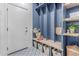 Stylish mudroom with custom blue built-ins, cubbies, and patterned tile flooring at 3030 E Camellia Dr, Gilbert, AZ 85296