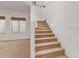 Carpeted staircase with white railing and ambient lighting on the side at 3030 E Camellia Dr, Gilbert, AZ 85296