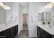 Bright bathroom with dual sinks, dark wood cabinets, and a linen closet, offering functionality and ample storage at 3113 E Danbury Rd # 10, Phoenix, AZ 85032